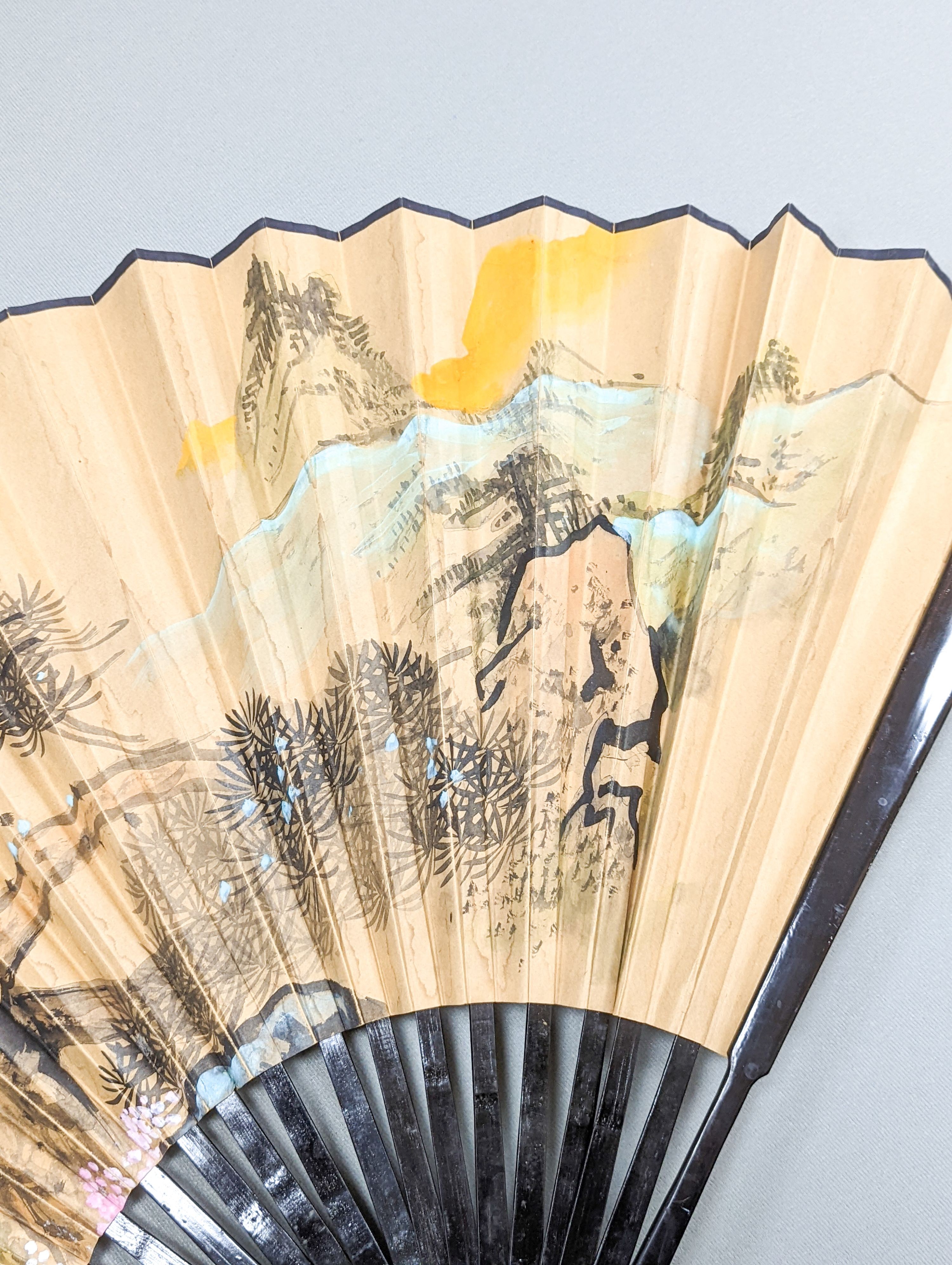 A large Chinese fan, the leaf painted with a landscape, signed Radius 60cm
